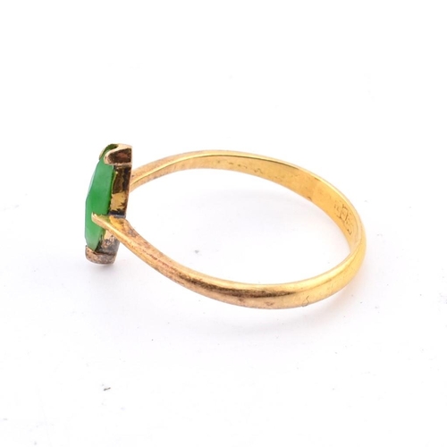 407 - A Chinese 22ct gold and jade ring. The 22ct yellow gold ring set with a single fancy cut jade to pol... 