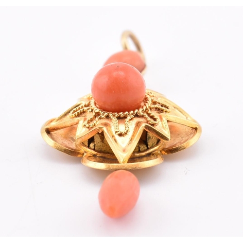 45 - A 15ct gold and coral locket pendant. The antique necklace pendant having a coral tassel surmounted ... 