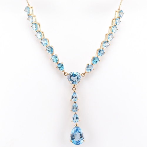 46 - A hallmarked 9ct gold and Swiss blue topaz pendant necklace. The 9ct yellow gold lariat necklace set... 