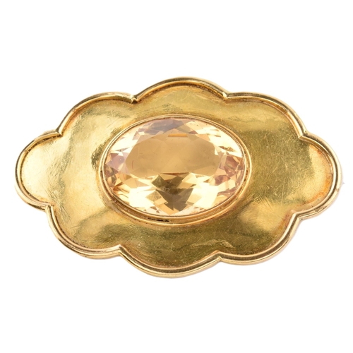 47 - A gold and citrine brooch pin. The brooch in the form of a cloud set with a central oval mixed cut c... 