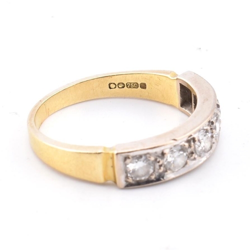 56 - A hallmarked 18ct gold and diamond half hoop ring. The 18ct yellow gold ring having six round brilli... 