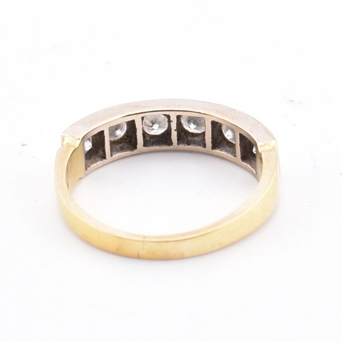 56 - A hallmarked 18ct gold and diamond half hoop ring. The 18ct yellow gold ring having six round brilli... 