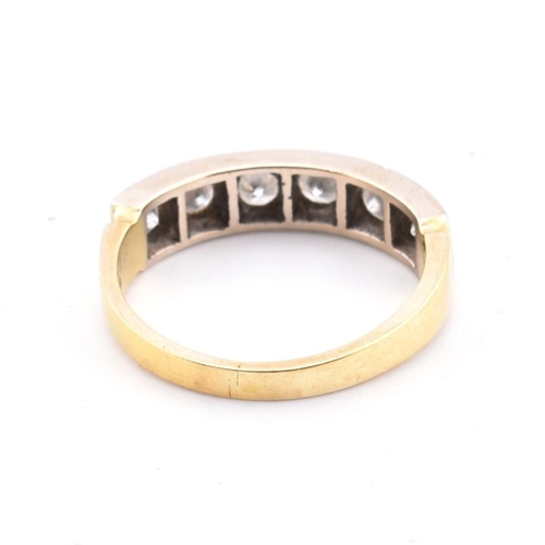 56 - A hallmarked 18ct gold and diamond half hoop ring. The 18ct yellow gold ring having six round brilli... 