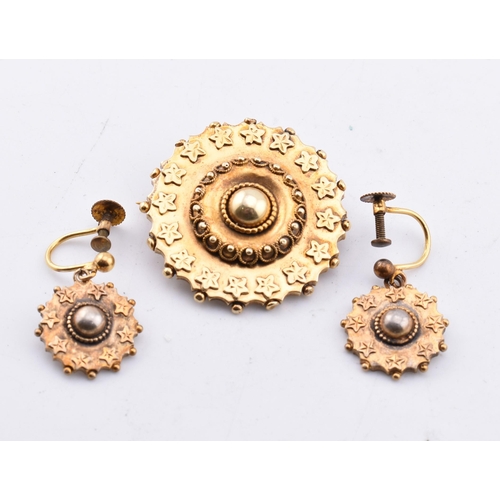 69 - A Victorian brooch and earring set. The antique rolled gold jewellery suite comprised of a round Etr... 