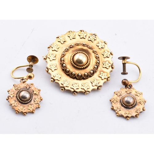 69 - A Victorian brooch and earring set. The antique rolled gold jewellery suite comprised of a round Etr... 