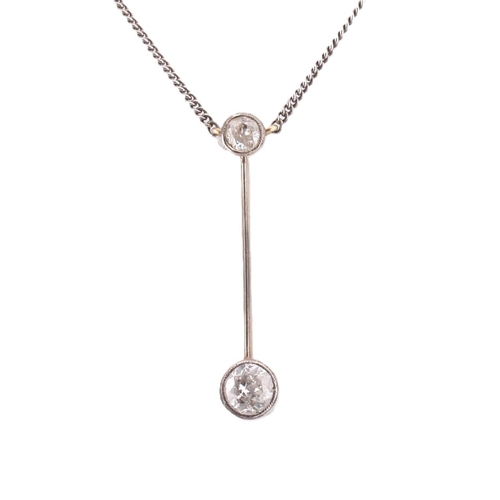 75 - A diamond pendant necklace. The diamond set lariat necklace having a millegrain set round cut diamon... 