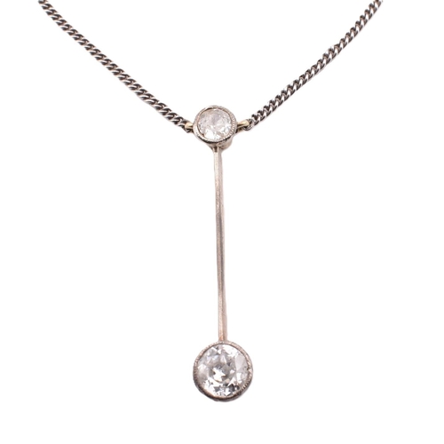 75 - A diamond pendant necklace. The diamond set lariat necklace having a millegrain set round cut diamon... 