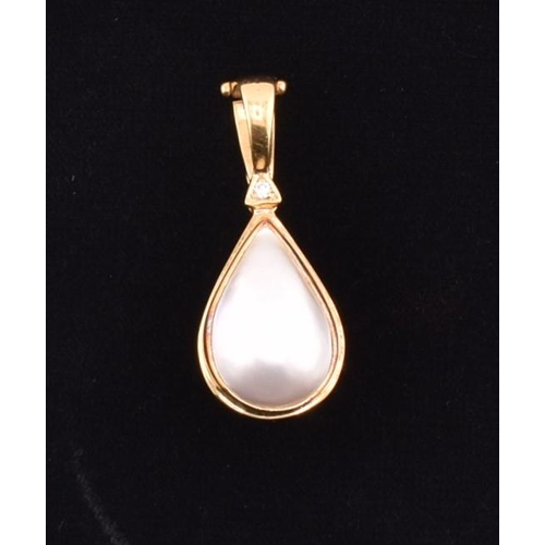 76 - A hallmarked 18ct gold, mabe pearl and diamond necklace pendant. The 18ct yellow gold necklace penda... 