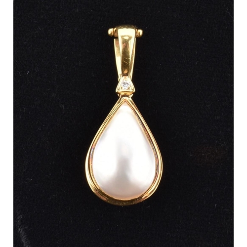 76 - A hallmarked 18ct gold, mabe pearl and diamond necklace pendant. The 18ct yellow gold necklace penda... 