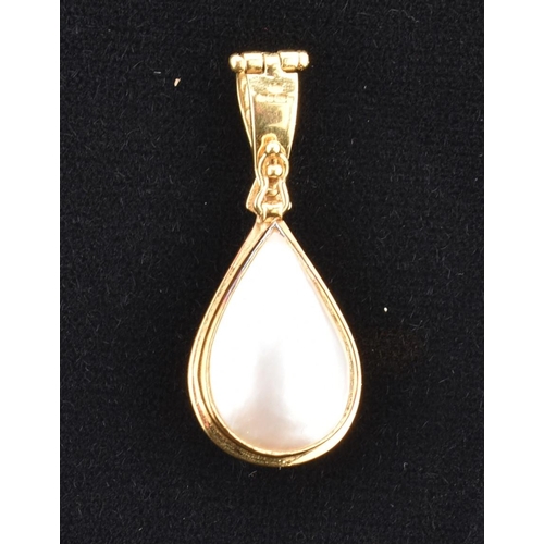 76 - A hallmarked 18ct gold, mabe pearl and diamond necklace pendant. The 18ct yellow gold necklace penda... 