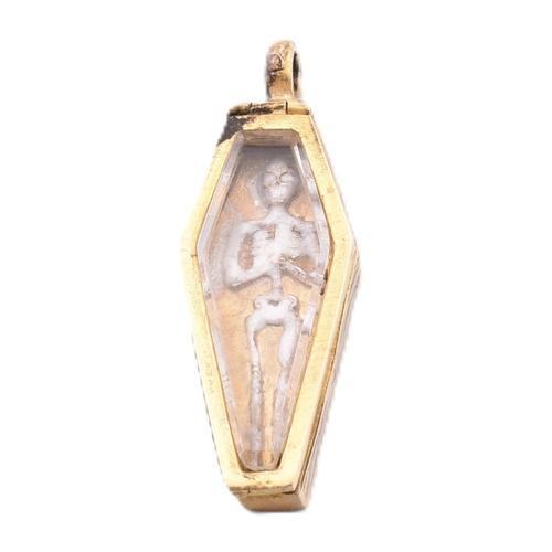 77 - A gilt and enamel coffin locket pendant. The gilt locket pendant in the form of a coffin having rock... 