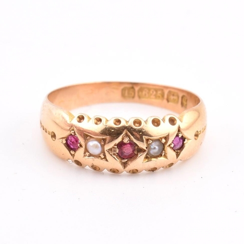 94 - A hallmarked 15ct gold ruby and pearl gypsy ring. The 15ct yellow gold ring set with three graduatin... 