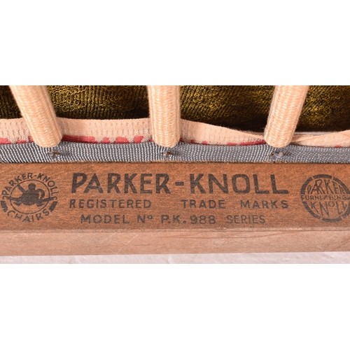 121 - Parker Knoll - a vintage mid century teak wood framed upholstered armchair. The chair featuring gree... 