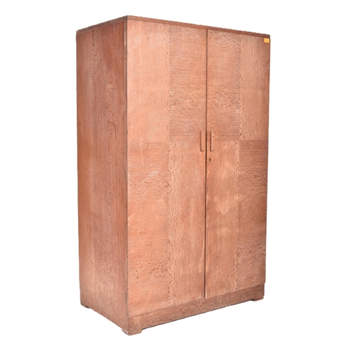 130 - Heals of London - a vintage 20th century 1930s Art Deco limed oak wardrobe. The wardrobe having two ... 