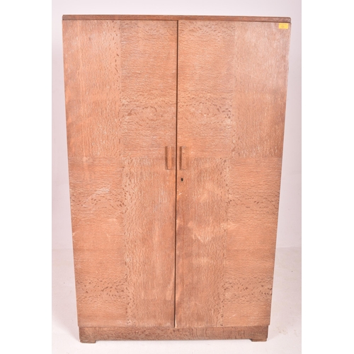 130 - Heals of London - a vintage 20th century 1930s Art Deco limed oak wardrobe. The wardrobe having two ... 