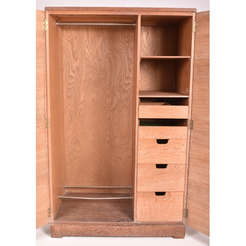130 - Heals of London - a vintage 20th century 1930s Art Deco limed oak wardrobe. The wardrobe having two ... 