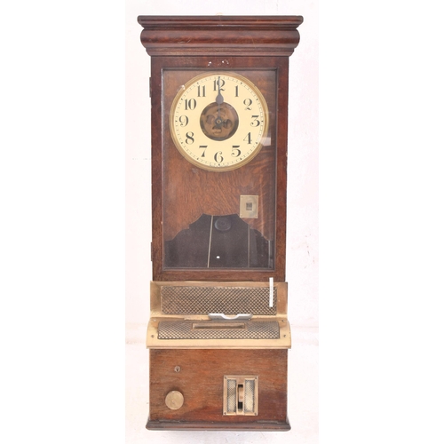 140 - National - an early 20th century oak cased time recorders clocking in machine. The glazed clock face... 