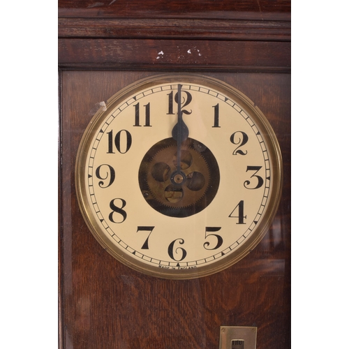 140 - National - an early 20th century oak cased time recorders clocking in machine. The glazed clock face... 