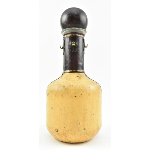 141 - An Italian vintage 20th century leather bound & glass crest decanter bottle. The decanter having... 