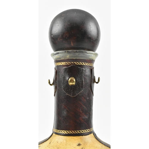 141 - An Italian vintage 20th century leather bound & glass crest decanter bottle. The decanter having... 