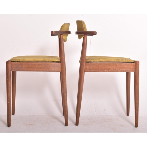145 - A matching set of four retro 20th century Danish teak framed dining chairs. Each chair having black ... 