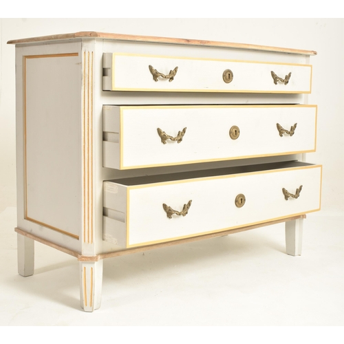 147 - A contemporary French-inspired oak-painted chest of drawers. The chest having a having a canted stri... 
