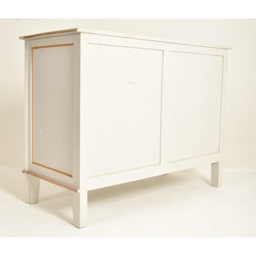 147 - A contemporary French-inspired oak-painted chest of drawers. The chest having a having a canted stri... 