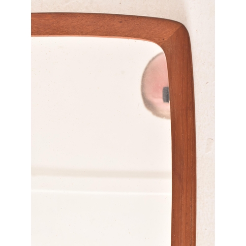 154 - A retro mid century Danish atomic teak framed hanging mirror. The mirror of rectangular form having ... 