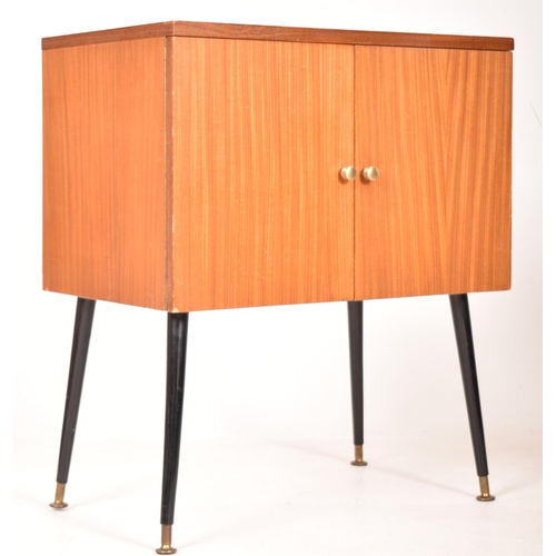 16 - A retro mid 20th century 1960s teak Hi-Fi record cabinet. The cabinet having twin doors opening to r... 