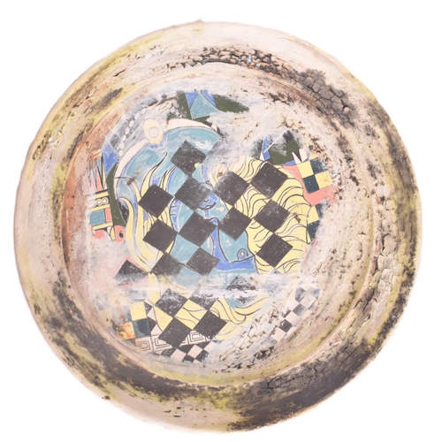 166 - A selection of 20th century studio art pottery charger plates. Each charger being hand-painted and m... 