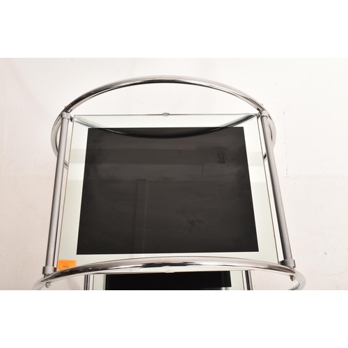168 - A vintage 20th century Art Deco style two tier cocktail drinks trolley. The circular chrome frame su... 