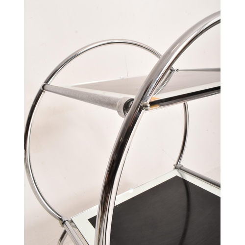 168 - A vintage 20th century Art Deco style two tier cocktail drinks trolley. The circular chrome frame su... 