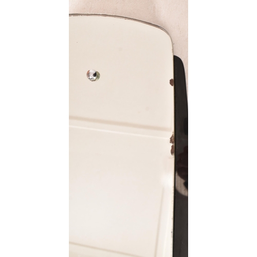 17 - A vintage 20th century Art Deco black glass framed hanging mirror. The mirror having a shaped mirror... 