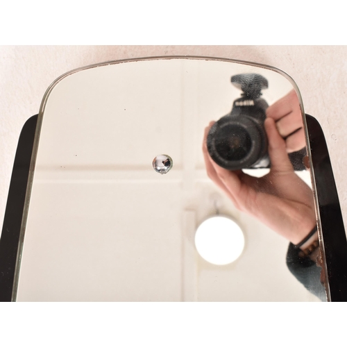 17 - A vintage 20th century Art Deco black glass framed hanging mirror. The mirror having a shaped mirror... 