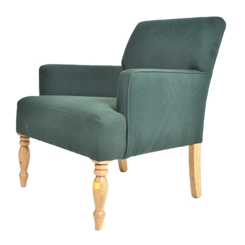 172 - A contemporary designer armchair. The chair having a padded seat and backrest with slender elbow sup... 