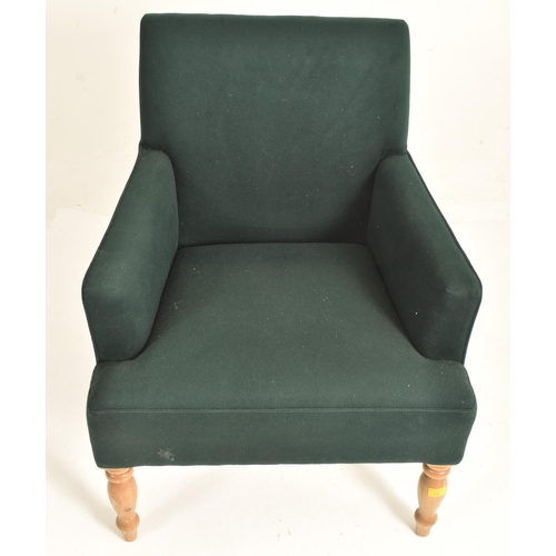 172 - A contemporary designer armchair. The chair having a padded seat and backrest with slender elbow sup... 