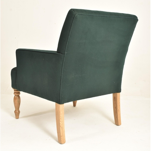 172 - A contemporary designer armchair. The chair having a padded seat and backrest with slender elbow sup... 