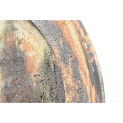 174 - A selection of 20th century studio art pottery charger plates. Each charger being hand-painted and m... 