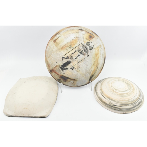 174 - A selection of 20th century studio art pottery charger plates. Each charger being hand-painted and m... 