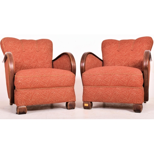 18 - A matching pair of vintage 20th century 1930s Art Deco club armchairs. Each chair having overstuffed... 