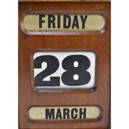 20 - A large mid century circa 1940s mahogany framed desk table perpetual calendar. The calendar with thr... 