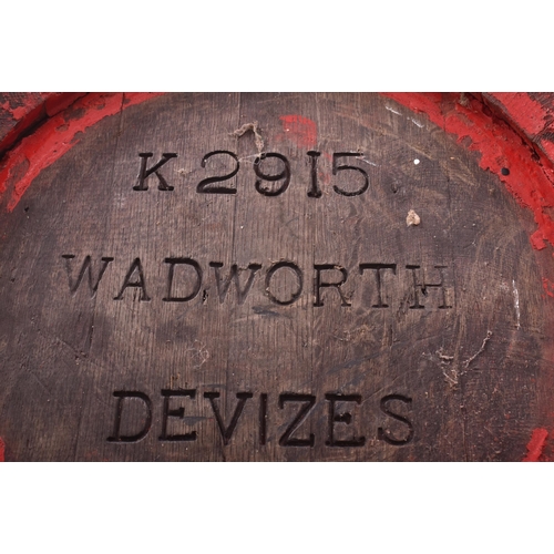 38 - Wadworth Devizes - a pair of wooden and metal bound coopered beer barrels / side lamp tables. Each o... 