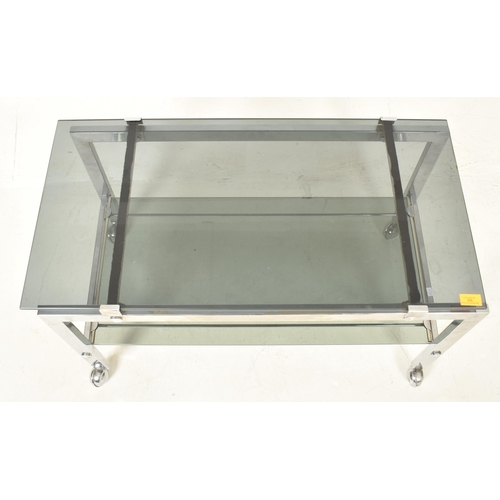 625 - 


A retro mid century 1970s Italian smoked glass and chrome drinks trolley. The cocktail trolley ta... 