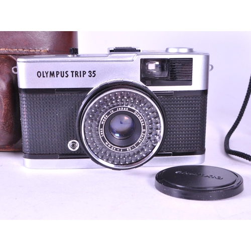 226 - Three late 20th century Olympus film camera and lens. Comprised of the 1979 Olympus OM 10 film camer... 