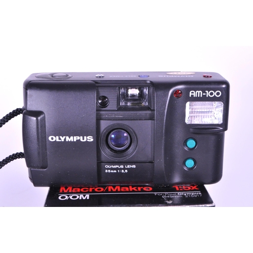 226 - Three late 20th century Olympus film camera and lens. Comprised of the 1979 Olympus OM 10 film camer... 