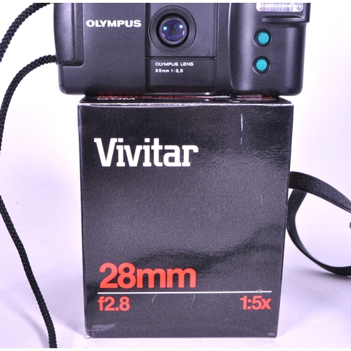 226 - Three late 20th century Olympus film camera and lens. Comprised of the 1979 Olympus OM 10 film camer... 