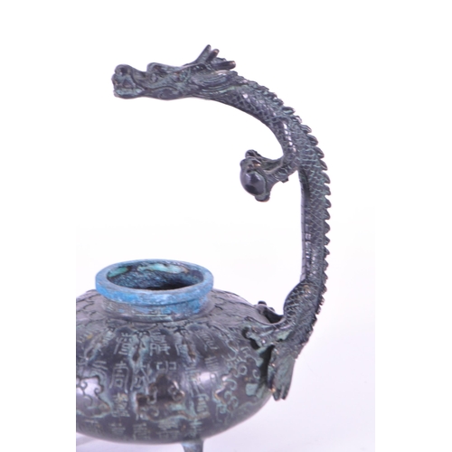 235 - 20th century Chinese bronze dragon statue incense. Features a dragon standing over a squat pot raise... 