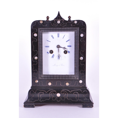 248 - An early 20th century French ebonized wooden mantel clock. The clock raised on block feet, with a st... 