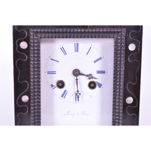 248 - An early 20th century French ebonized wooden mantel clock. The clock raised on block feet, with a st... 