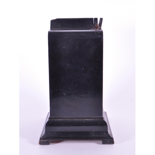 248 - An early 20th century French ebonized wooden mantel clock. The clock raised on block feet, with a st... 